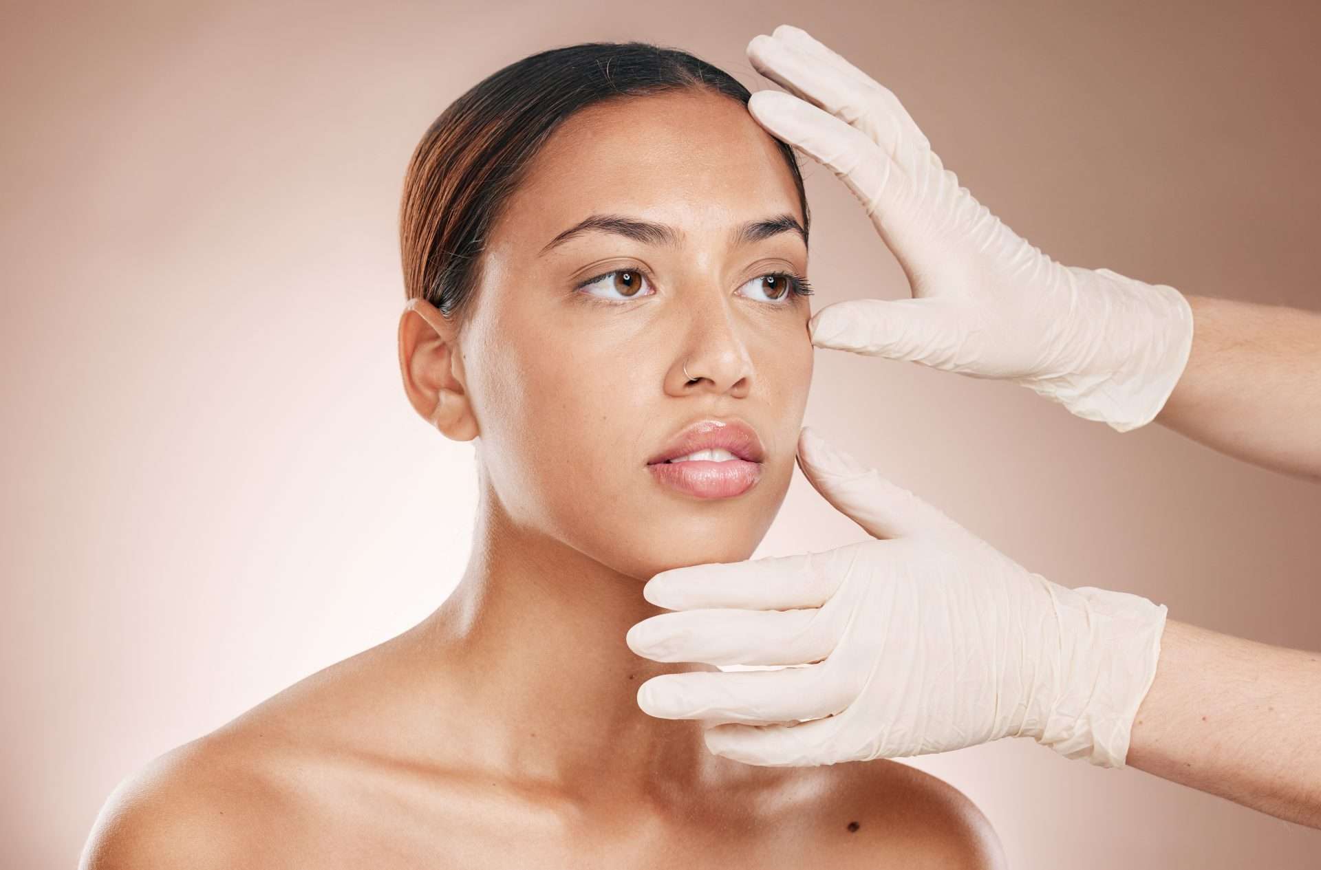 lady getting her face assessed by an esthetician