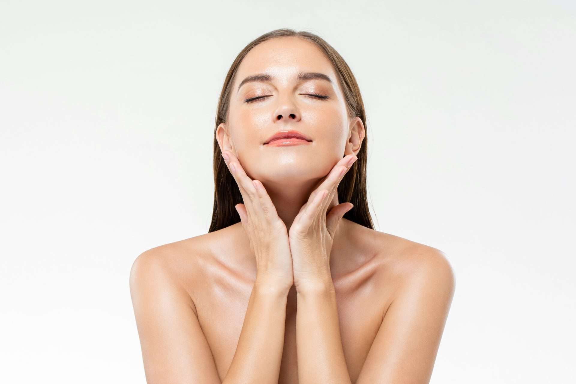 woman touching her glowing skin